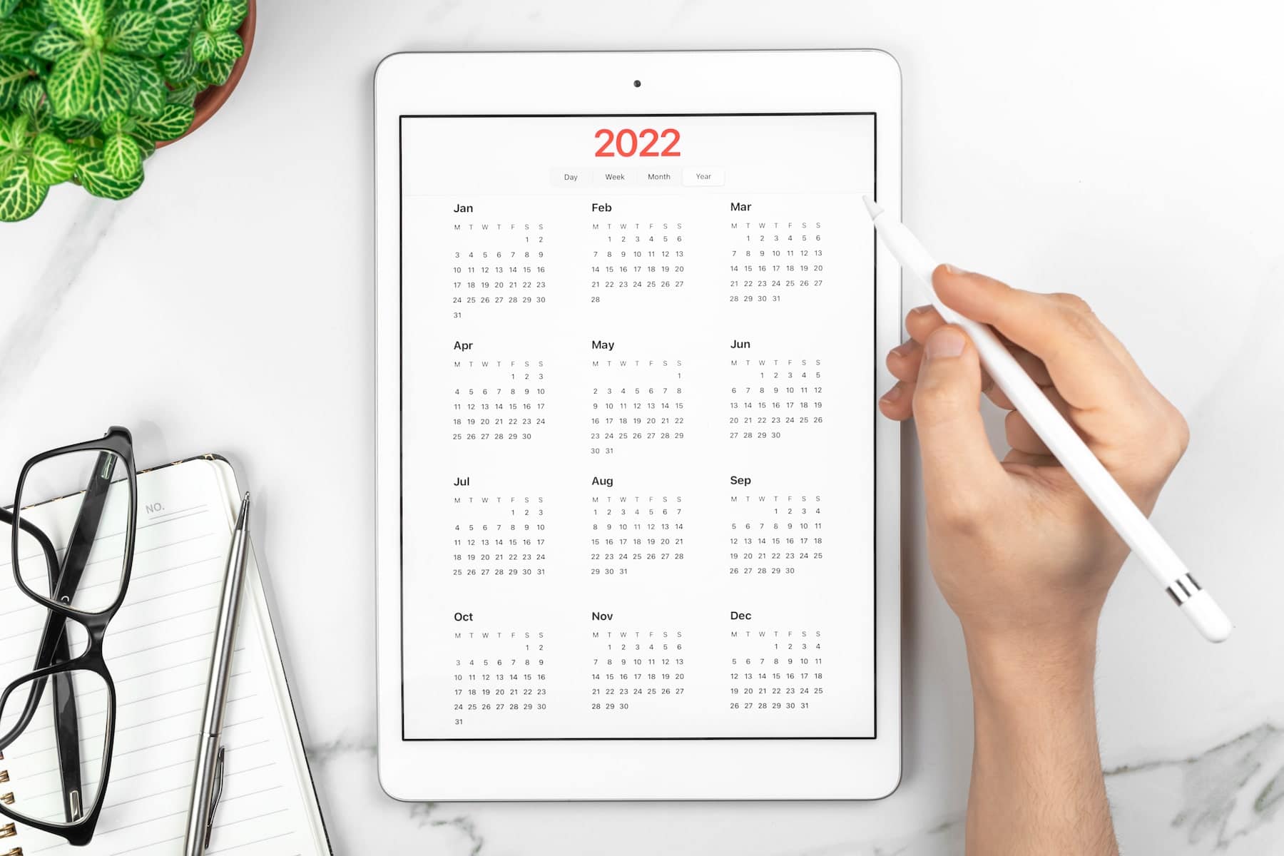 calendar 2022 reminder management concept tablet computer with open app white marble background business desktop goals planning new year concept top view flat lay photo min